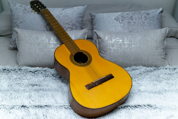 istock Spanish guitar on white bed 1216454999