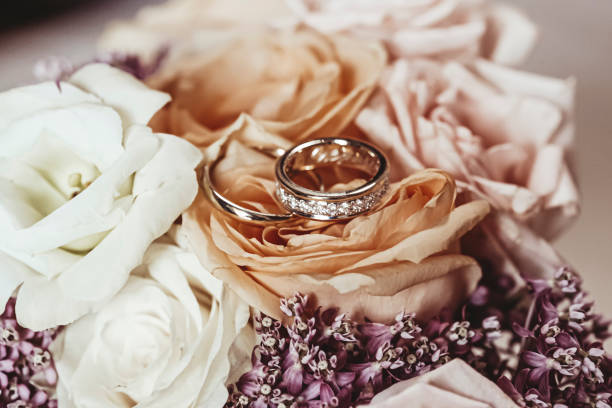 istock A pair of wedding rings placed on a wedding bouquet 1216456727