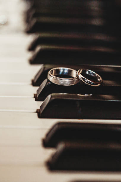 istock Wedding rings on a piano 1216456835