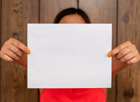 A woman holding blank paper