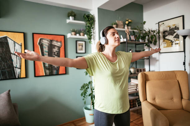 istock Adult woman exercising at home during quarantine 1216458698
