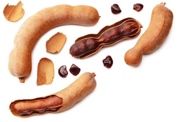 istock fresh tamarind fruits isolated on white background. top view 1216459833