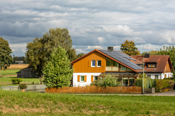 single family home with solar cells in bavaria - european alps mountain house bavaria imagens e fotografias de stock