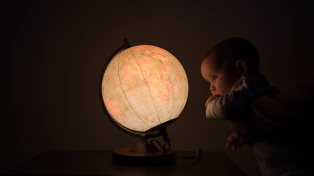 istock New born baby looking at the globe 1216461171