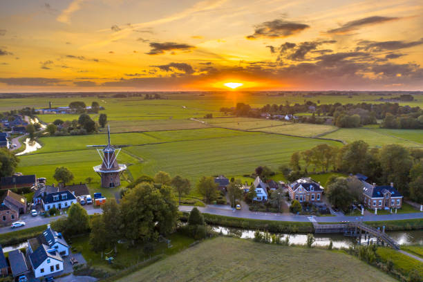 Aerial view of dutch countryside Aerial view of sunset over dutch village in agricultural countryside landscape, Groningen, Netherlands. netherlands aerial stock pictures, royalty-free photos & images
