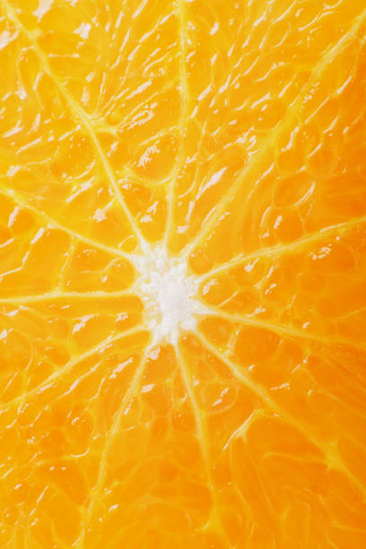 istock juicy fresh ripe orange in a section close-up, macro 1216462508