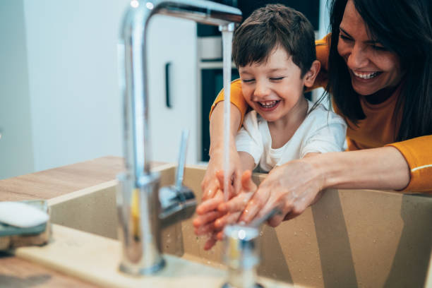 Washing hands Mother and son have fun washing their hands hand-hygiene-day stock pictures, royalty-free photos & images