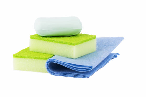 istock Two kitchen sponges, antiseptic soap and napkins are isolated on a white background. 1216463577