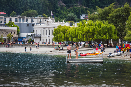 People at the beach of Queenstown New Zealand, South Island. Queenstown, New Zealand - December 17 2017.
