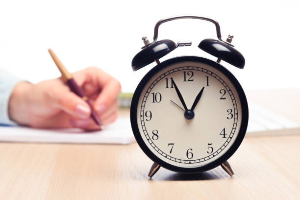 istock alarm clock on the background of the office 1216464115