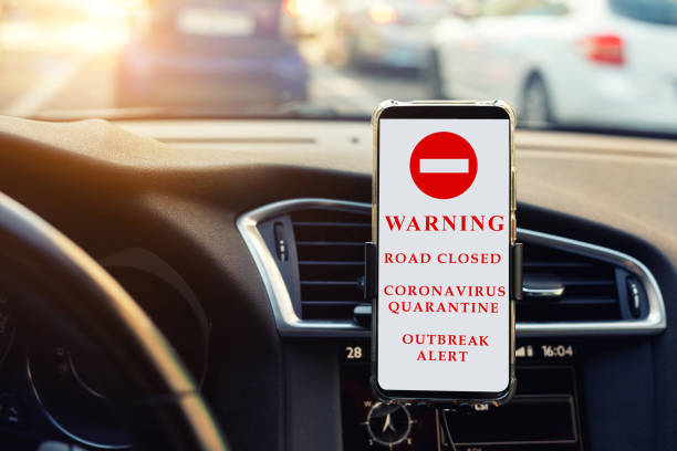 Warning sign crossed out smartphone in a yellow triangle on a light background close-up