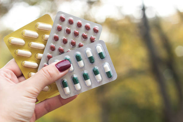 istock Woman holding blister packs 1216465976