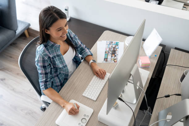 istock Female designer working at a creative office editing with a pen tablet 1216468657