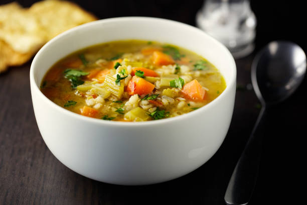 Healthy vegan broth Home made freshness carrot,barley,celery,green lentils  broth with focaccia bread soup stock pictures, royalty-free photos & images