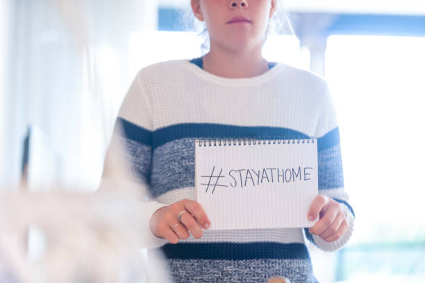 istock Woman holding a #stayathome sign. 1216470335