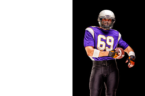 In action. American football player isolated on white studio background with copyspace. Professional sportsman during game playing in action and motion. Concept of sport, movement, achievements.