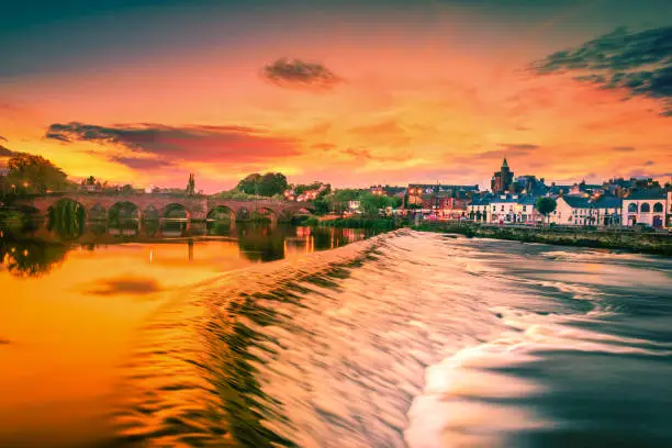 The River Nith and old bridge at sunset in Dumfries, Scotland.