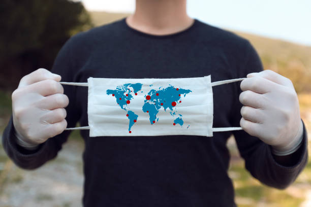 istock White face mask with a map of the world 1216475993