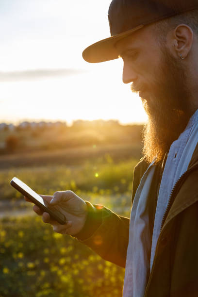 istock Young modern hiker consulting his mobile phone at sunset 1216479224