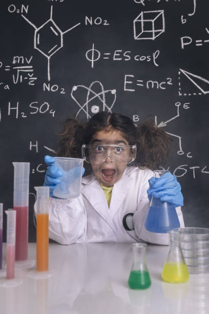 istock crazy scientist girl with chemical flasks 1216484379