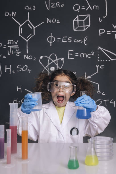 istock funny scientist girl in lab coat with flasks 1216484397