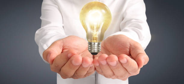 istock Hand of holding illuminated light bulb. innovation inspiration concept 1216484561