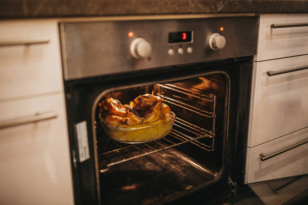 istock Chicken and potatoes baking in the oven 1216485422