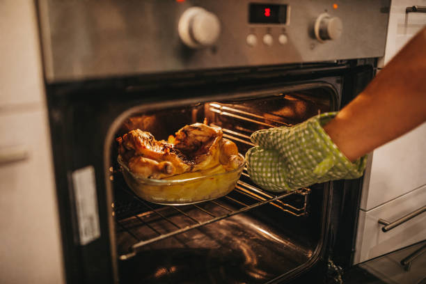 istock Chicken and potatoes baking in the oven 1216486179