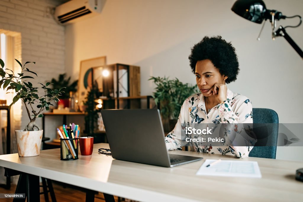 Hispanic business woman working from home Busy hispanic business woman working from home office Working At Home Stock Photo