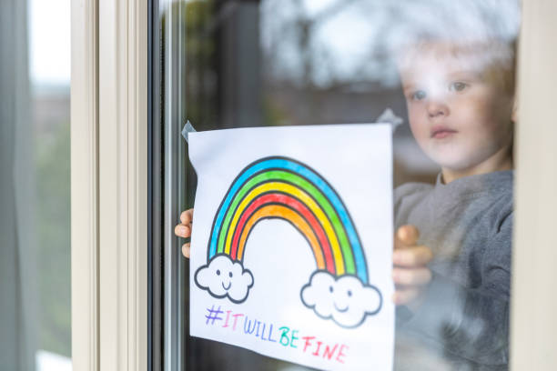 istock Young Boy sticking his drawing on home window during the Covid-19 crisis 1216489525