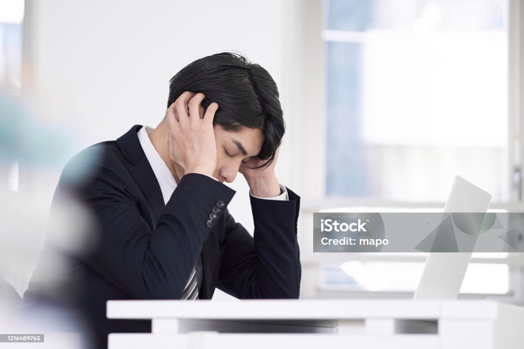 Japanese male businessmen Japanese male businessmen with worries Worried Stock Photo
