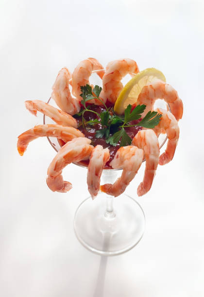 istock Shrimp cocktail in a martini glass on light background. 1216489814