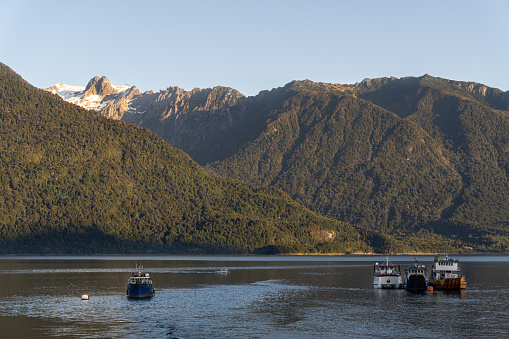 Boats at the fjords of the Chilean Patagonia in Los Lagos region, southern Chile