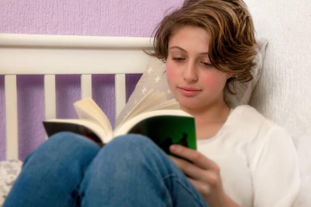 istock Teen reading in his room 1216492618