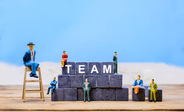 istock business teamwork concept with miniature toy, on blue background, copy space for text 1216493443