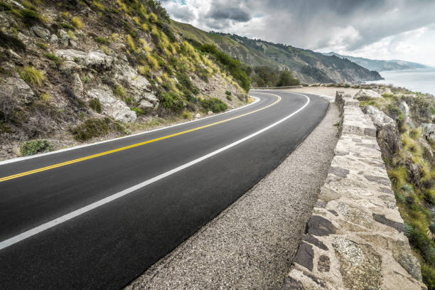 istock empty mountain highway in California 1216495096