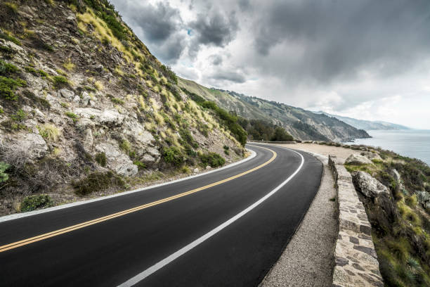 istock empty mountain highway in California 1216495097
