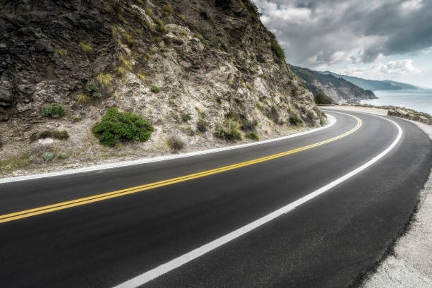 istock empty mountain highway in California 1216495127