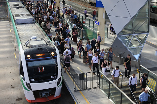 Perth, Western Australia - January 16, 2020: Commuters board and disembark a train in Perth railway station. Perth Railway Station is the largest station on the Transperth network serving the central business district of Perth, Western Australia.