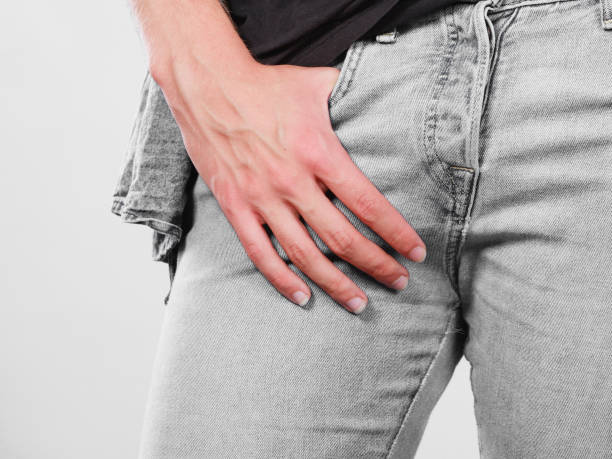 istock Guy hand in the pocket of grey jeans 1216514070