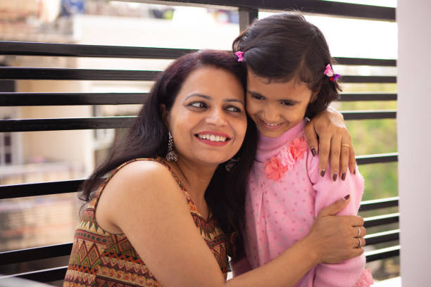 istock Mother and daughter bonding in balcony 1216516797