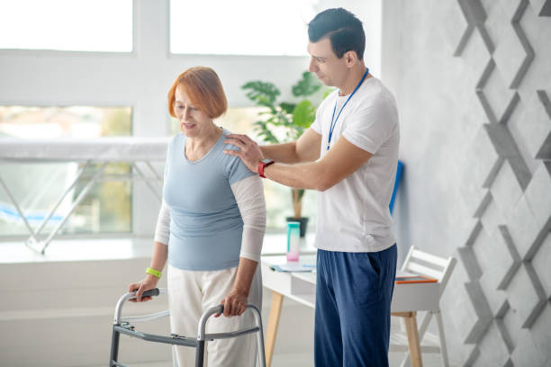 istock Professional young doctor standing behind his patient 1216516865