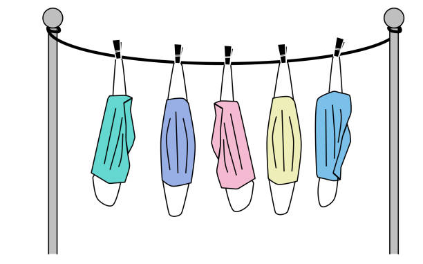 gesichtsmasken auf dem trockengestell. - laundry clothing clothesline hanging stock-grafiken, -clipart, -cartoons und -symbole