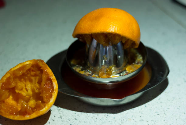istock Orange juice with the juicer 1216517956