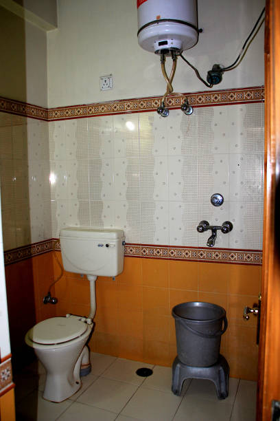 Interior of Modern Bathroom View of inside of modern bathroom with commode, geyser, tiled walls, floor and other accessories bathroom geyser stock pictures, royalty-free photos & images