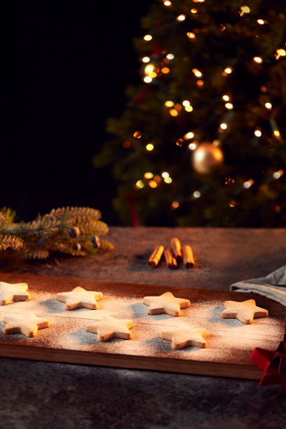 istock Freshly Baked Star Shaped Christmas Cookies On Board Dusted With Icing Sugar 1216524492