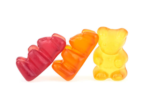 istock Three gummy bears on a white background. Colorful gel bear dessert. 1216524499