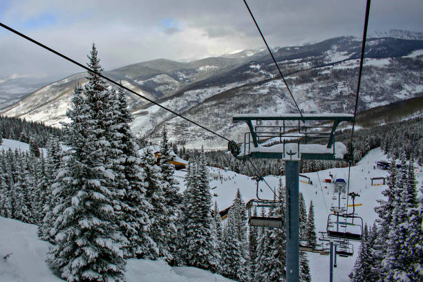 istock Empty ski lift by snowy evergreen tree in Vail, Colorado 1216524973