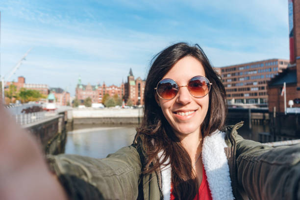 istock Tourist making selfies / vlogging in Hafen City 1216525148