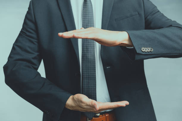 Hands of a man in a blue jacket folded left a place between the palms or as if pulling something. Hands of a man in a blue jacket folded left a place between the palms male is standing and shows outstretched hand with open palm stock pictures, royalty-free photos & images